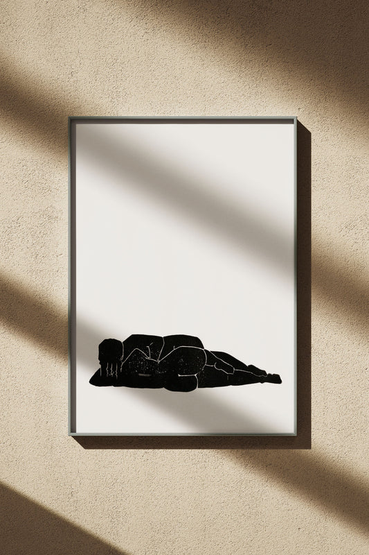 Designstudio Labim: Das Bild zeigt den Linoldruck "Liegen & Lieben". Das Bild hängt an einer Wand im Sonnenschein